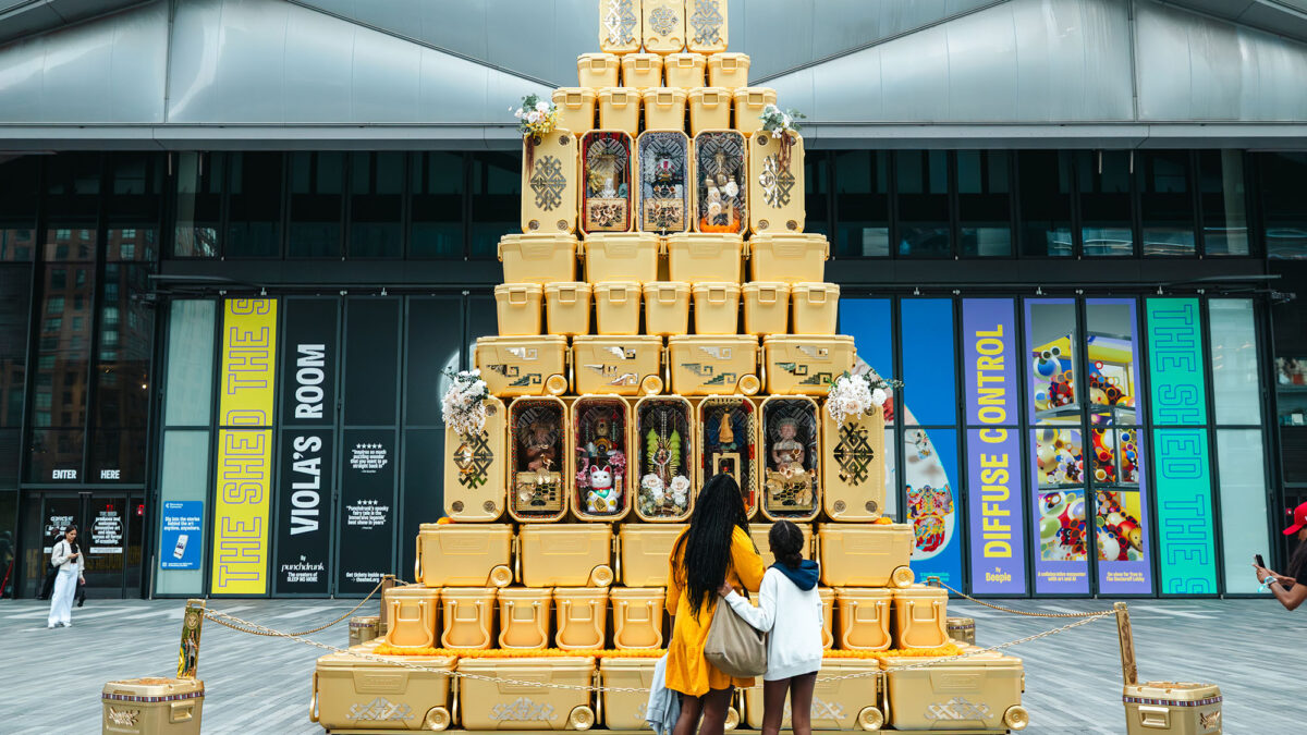 Victor “Marka27” Quiñonez’s Elevar La Cultura sculpture made from stacked golden coolers, shown at an earlier installation.